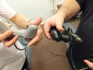 Illustration for article titled Men Massaging Each Other With Video Game Controllers